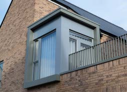 A bespoke configuration of Skyline Aluminium Window Surrounds, Coping and Fascia